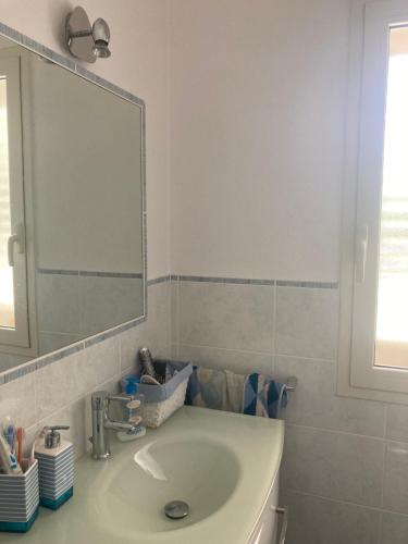 a bathroom with a sink and a mirror at Casa Smeralda in Olbia