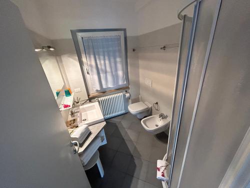 a small bathroom with a sink and a toilet at Gardesana Active Apartments in Malcesine