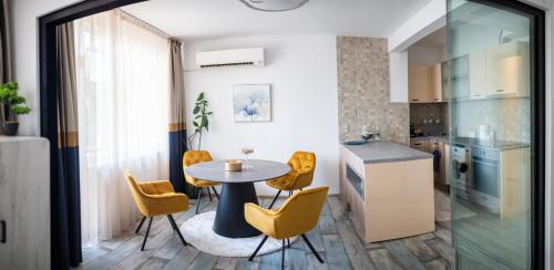 a kitchen and dining room with a table and chairs at A&K KOZY ART Studio 2 in Varna City