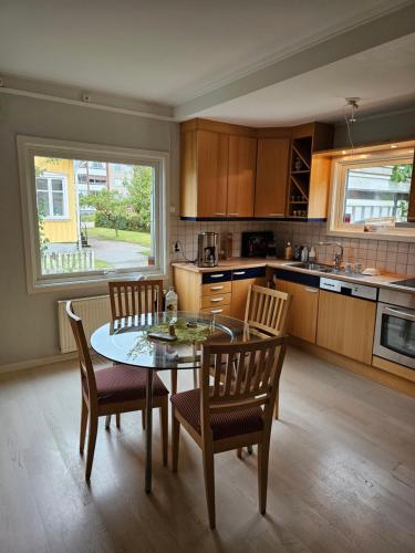 a kitchen with a table and chairs and a table and a window at Villa Sandgatan in Falkenberg