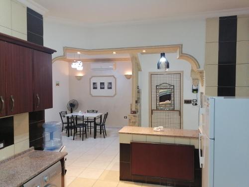 a kitchen and dining room with a table and a refrigerator at Yaso Roof & Apartments in Amman