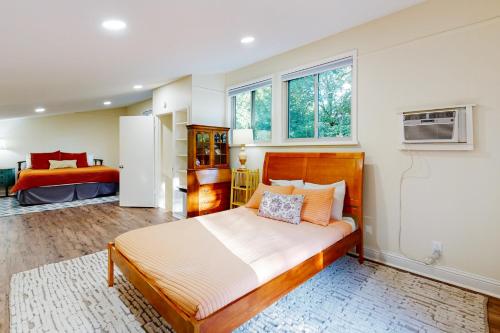 ein Schlafzimmer mit einem großen Bett und zwei Fenstern in der Unterkunft Mulberry Manor in Fayetteville