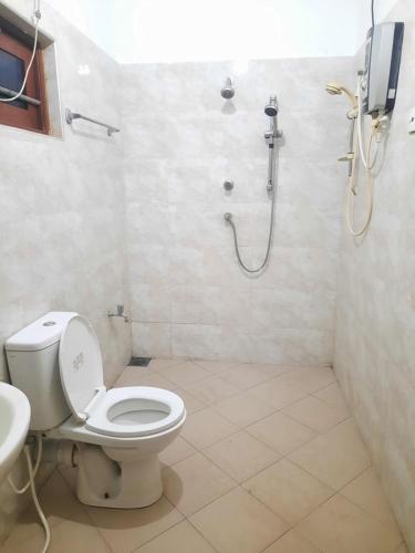 a bathroom with a toilet and a shower at Nature Resort in Galle