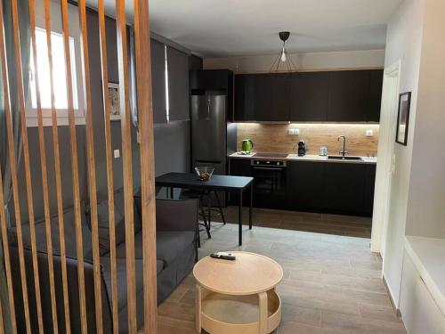 a kitchen with a table and a kitchen with a dining room at Chic fully equipped Studio Apart - Netflix - Wi-Fi in Piraeus