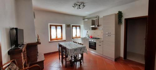 a kitchen with a table and a stove top oven at Casa Badia in Radda in Chianti