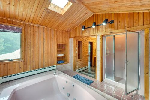 a large bathroom with a tub and a shower at Cozy Livingston Manor Home with Wood-Burning Stove! in Livingston Manor