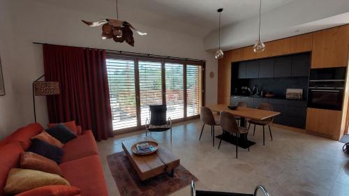 a living room with a couch and a table at Lodge Les Oliviers in Garéoult