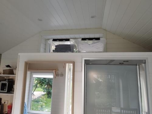 a room with a ceiling with a door and a window at Guest House in the Garden in Hokksund