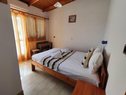 a bedroom with a bed with two towels on it at Oleander's Garden Traditional Cretan Cottage in Ferma