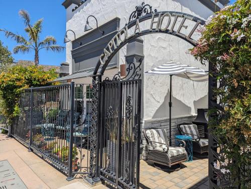 a gate to a house with an umbrella at Capitola Hotel in Capitola