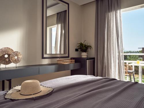 a bedroom with a bed with a hat on it at Nastazia Studios in Laganas