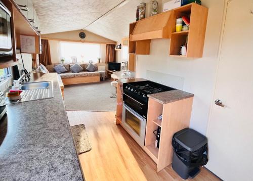a kitchen and living room in a tiny house at Lola’s Caravan. Your home away from home. in Parkeston