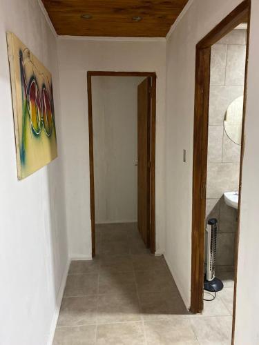 a hallway with a door to a room with a bathroom at Luna Nueva in Concepción del Uruguay