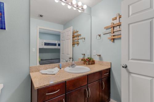 a bathroom with a sink and a mirror at Laketown Wharf 335! 1 BD, 2 Bathroom with Amazing Amenities in Panama City Beach
