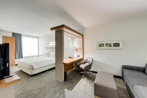 a hotel room with a bed and a desk at SpringHill Suites by Marriott Houston The Woodlands in The Woodlands