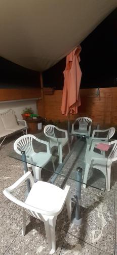 a group of white chairs sitting on a patio at appartamento vale in Viareggio