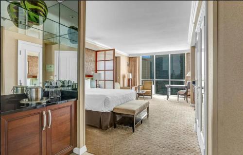 a hotel room with a bed and a bathroom at Signature MGM Suite with Strip and Sphere View in Las Vegas