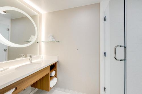 a bathroom with a sink and a mirror at SpringHill Suites by Marriott Houston The Woodlands in The Woodlands