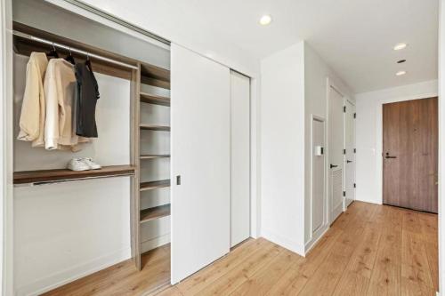 a walk in closet with white walls and a sliding door at Level Chicago - River North in Chicago