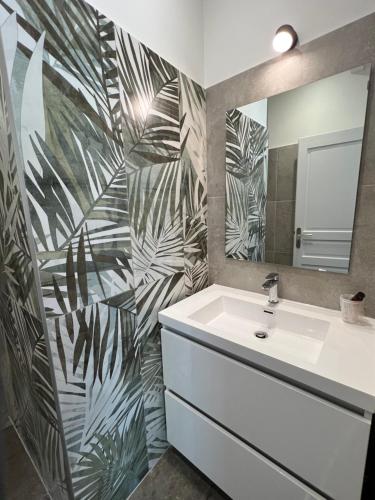 a bathroom with a sink and a mirror at Domaine de l'Aufrene in Hyères