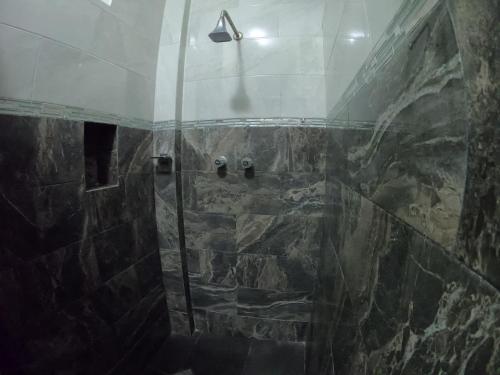 a shower with a glass door in a bathroom at Bacalar in Bacalar
