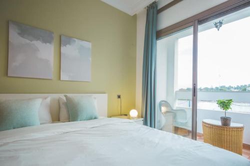 a bedroom with a large bed and a large window at lovely 2 bedroom vacation home with pool/beach in Skhirat