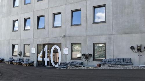 a building with couches sitting outside of it at BUSINESS-MOTEL, free XL-Parking, eCharging, Self Checkin, Massage, Sauna in Heimsheim