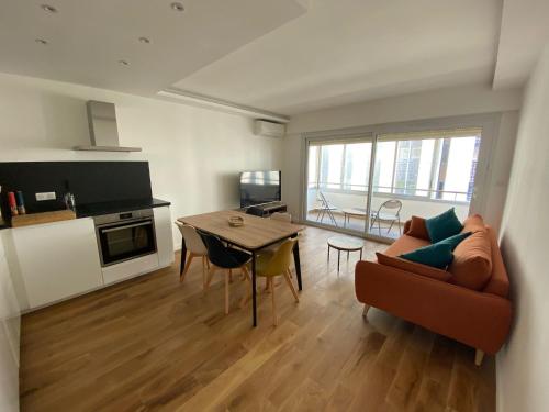 un salon avec un canapé et une table dans l'établissement Renovated 4 room Apartment-Parking next door and Beach at 700m, à Antibes