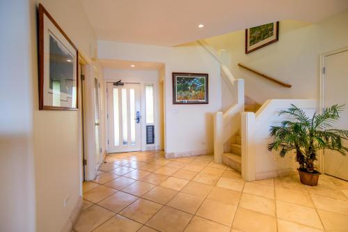 a hallway with a staircase and a potted plant at Kapalua Villas Maui - Select Your Unit in Kahana