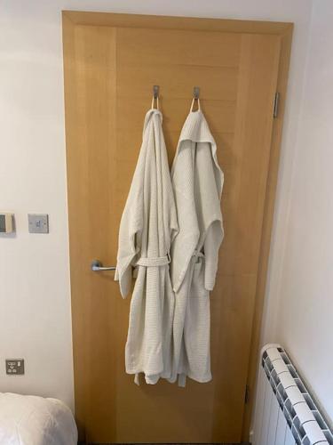 a bathroom with white towels hanging on a door at Sea view - 2 bedroom - West Pier - Brighton Beach in Brighton & Hove