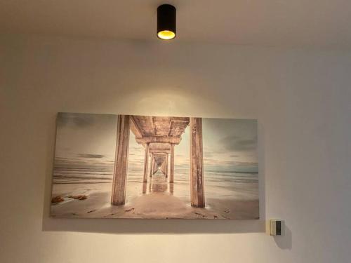 a painting of a pier hanging on a wall at Sea view - 2 bedroom - West Pier - Brighton Beach in Brighton & Hove