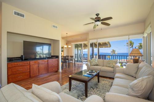 a living room with a couch and a flat screen tv at Kapalua Villas Maui - Select Your Unit in Kahana