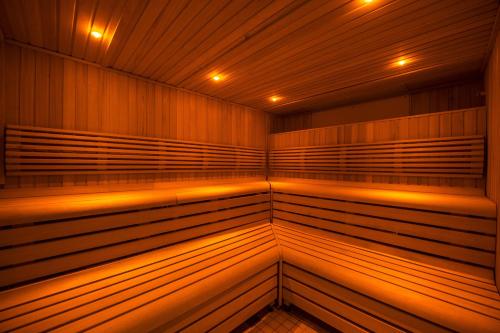 an empty sauna with wooden walls and lights at Fonab Castle Hotel in Pitlochry