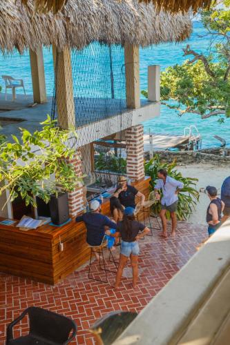 a group of people standing on a beach at Hotel Isla Del Pirata in Isla del Pirata