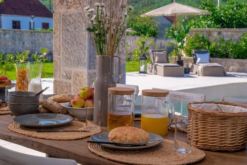 a wooden table with food and drinks on it at Villa Cera in Unešić
