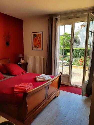 a bedroom with a bed and a sliding glass door at A la Volette in Pouillé