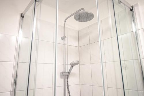 a shower with a shower head in a bathroom at Ferienhaus im Altstadtgässchen mit 3 Badezimmern in Quedlinburg