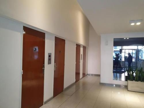 a hallway of a building with several elevators and doors at Tu mejor opción en Mar del Plata. Cerca de todo. in Mar del Plata
