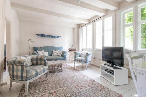 ein Wohnzimmer mit einem Sofa und einem TV in der Unterkunft Das Fachwerkhäuschen am Kornmarkt - herzlich & charmant in Quedlinburg