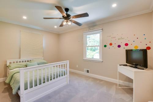 a baby room with a crib and a ceiling fan at Rockville Home Patio Oasis, Fireplace, Near DC! in Rockville