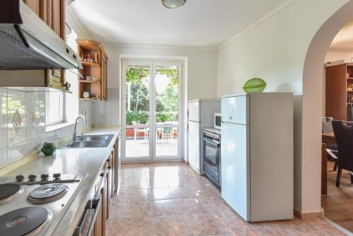a kitchen with a white refrigerator and a table at Vizmeg Holiday Home in Dubrovnik