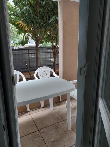 an open door with a table and chairs on a patio at ROSNY15 in Rosny-sous-Bois