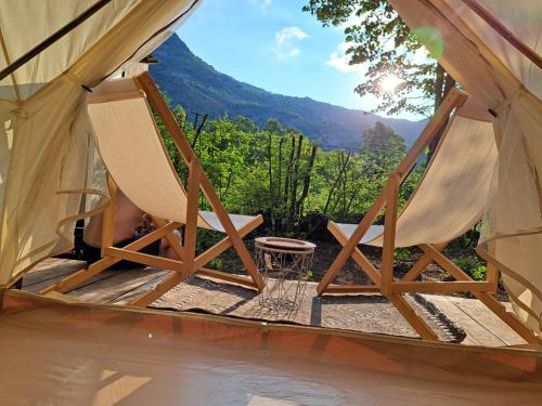 a couple of chairs in a tent with a table at glamping Shangri la 