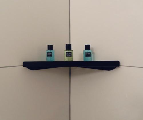 a shelf with three bottles on top of a wall at White Moon Inn in Jerusalem