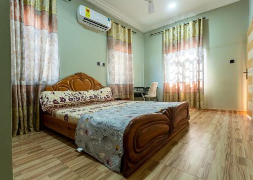 a bedroom with a large bed and a table in it at NKA Properties in Apenkwa