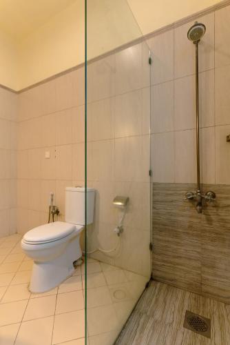 a bathroom with a toilet and a glass shower at Renaissance Hotels in Islamabad