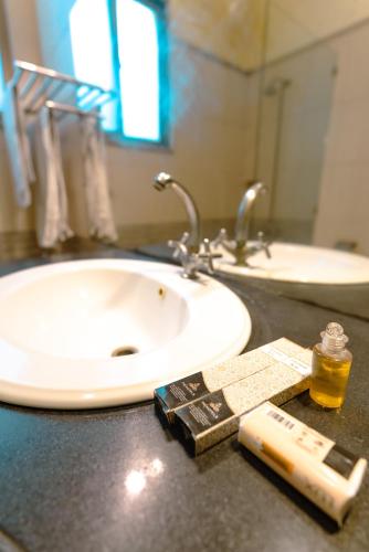 a bathroom counter with a sink and a book and a toothbrush at Renaissance Hotels in Islamabad