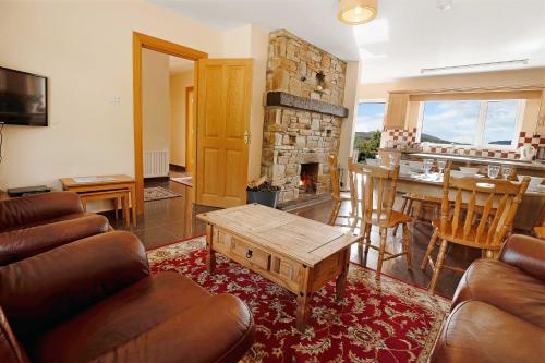 a living room with a couch and a table at Bradleys Cottage Creeslough in Creeslough