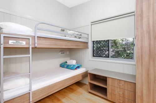 a small room with a bunk bed and a window at Reflections Corindi Beach - Holiday Park in Corindi