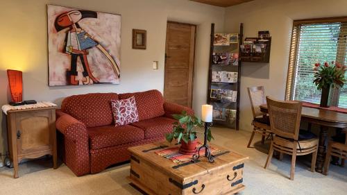 a living room with a couch and a table at Tussock Cottage in Queenstown